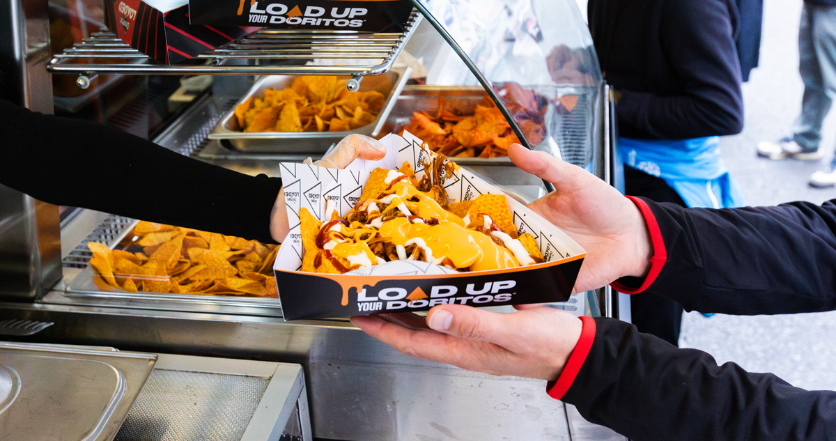 Doritos dish being handed off from a Doritos Loaded truck