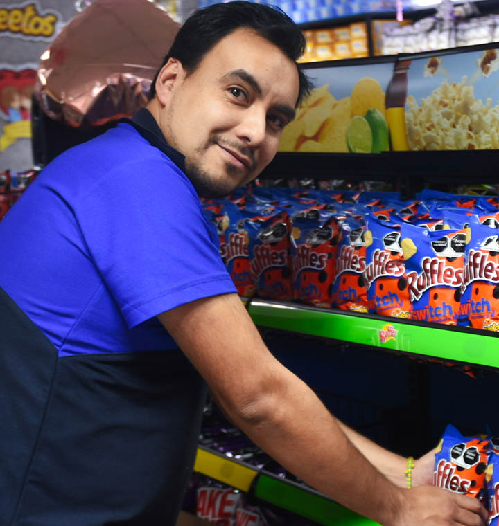 PepsiCo frontline employee stocking shelves