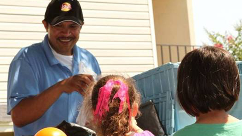 Pedro Garcia, one of Food for Good’s longest-serving team members, passes out food in the program’s early days.