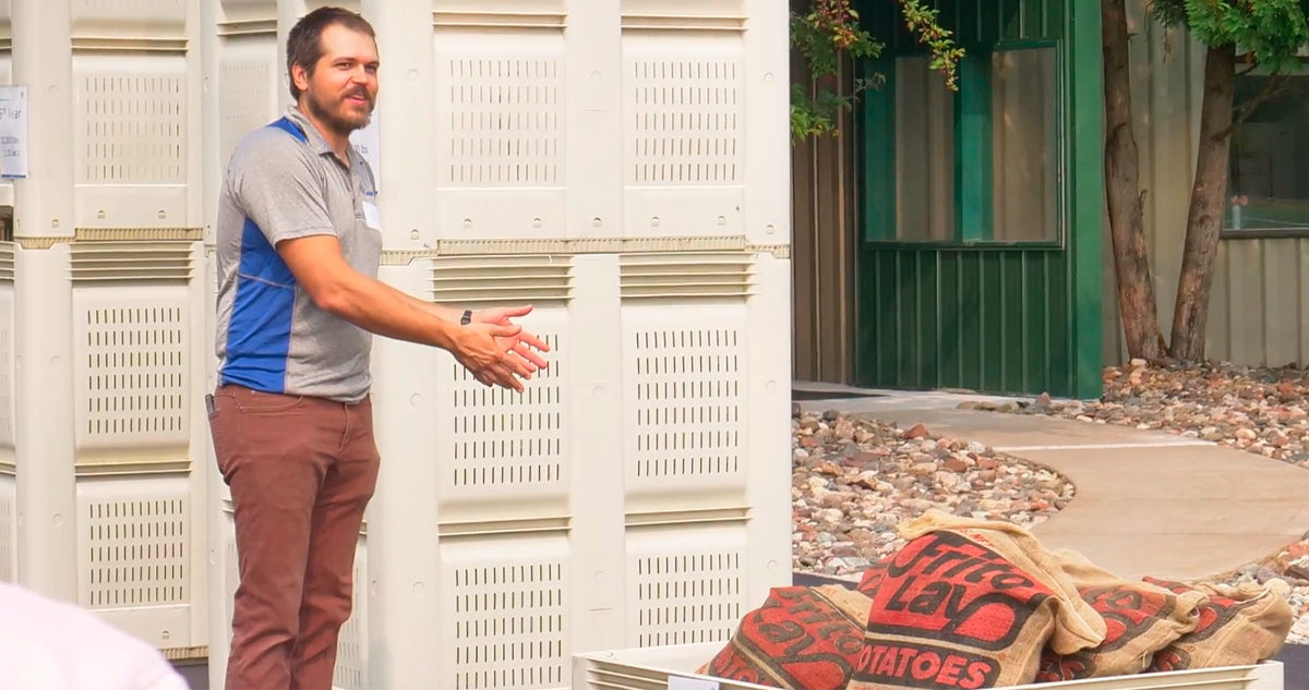 Josh Parsons gesturing to bags of Frito-Lay potatoes