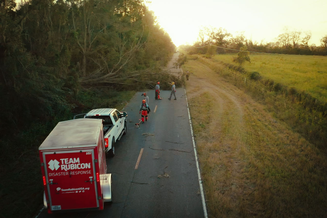 Team Rubicon inspecting a fallen tree on a road