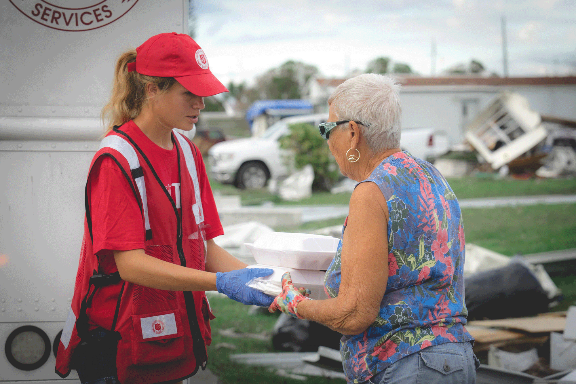 Salvation Army handing food to a woman