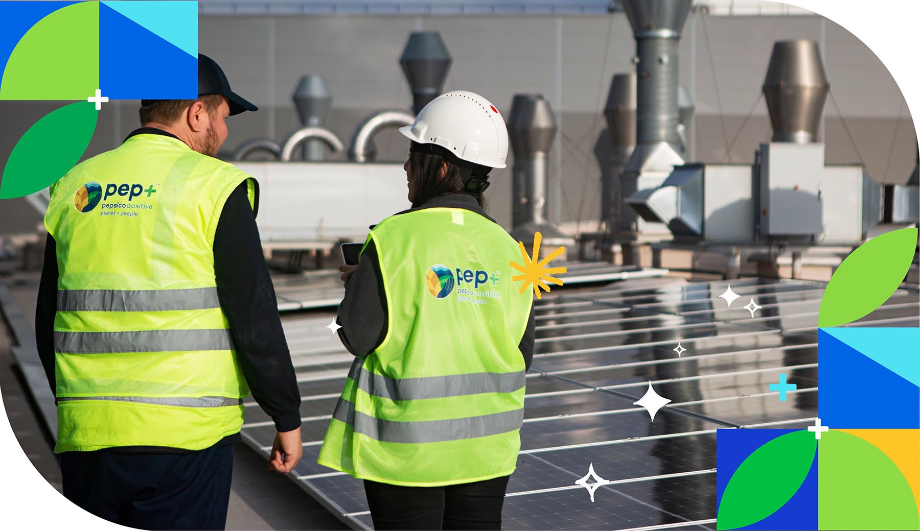 Two workers in PepsiCo Positive safety vests in front of solar panels
